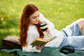 Enjoying a moment of relaxation with a book and coffee in a sunny park setting