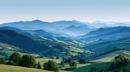 Obraz premium Serene landscape featuring rolling hills under a clear sky, with layered mountains in the background, creating a tranquil atmosphere.