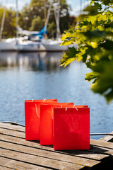 Red shopping bags during sunny day with blue sky background