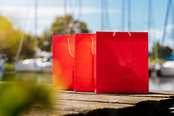 Red shopping bags during sunny day with blue sky background