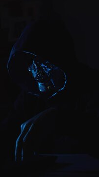 Hacker masked in hoodie exploring dark web on laptop illustrating cyber espionage and digital risk