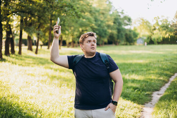 Sad blonde man got lost and could not find an internet connection on phone on the nature...