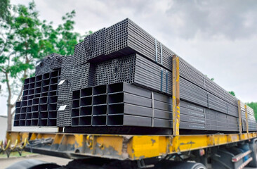 Rectangular hollow steel tubes stacked for industrial use, commonly applied in structural framing,...