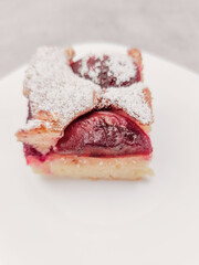 Delicious plum cake with powdered sugar topping