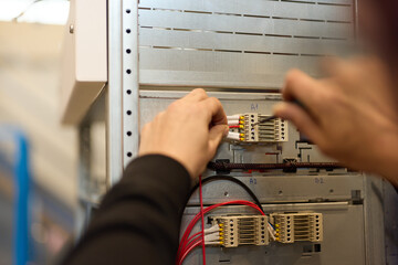 Technician Assembling Electrical Components Inside a Mechanical Panel