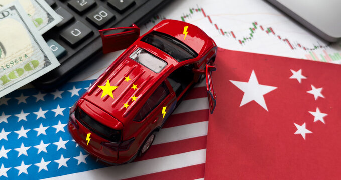 China and United States of America trade competition. United States of America and China flags with American dollars and electric car from China