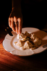 Delicious khinkali served with creamy sauce at an intimate dining setting