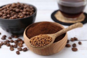 Different types of instant coffee and beans on white table, closeup