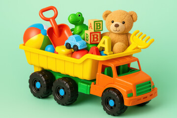Colorful toy truck carrying toys for kids on green background