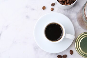 Aromatic hot drink, instant coffee and beans on white marble table, flat lay. Space for text