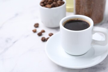 Aromatic hot drink, instant coffee and beans on white marble table, closeup. Space for text