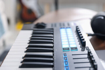 One portable MIDI keyboard indoors, closeup view