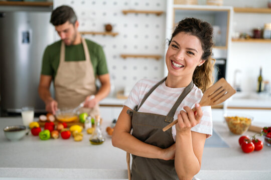 Professional personal chef cook in customer's private kitchen, giving a cooking lesson to people