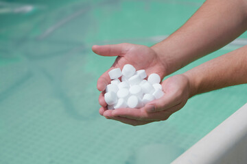man hands holding salt for cleaning the pool