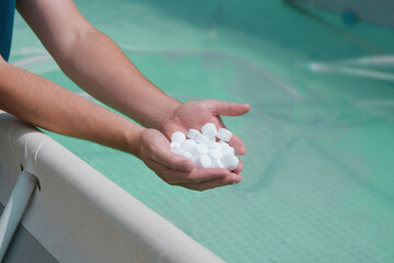 man hands holding salt for cleaning the pool