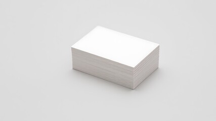A neat stack of blank white business cards rests on a clean light gray surface ready for personalization and branding