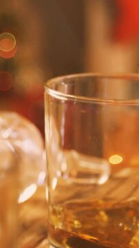 Animation of christmas drink being poured into glass with flickering fairy lights