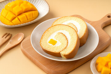 Delicious mango cream Swiss roll cake on plate