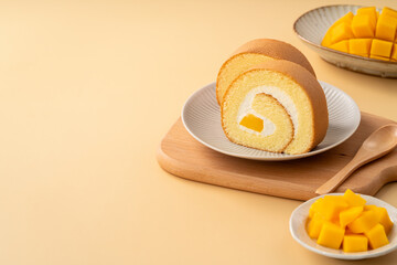 Delicious mango cream Swiss roll cake on plate