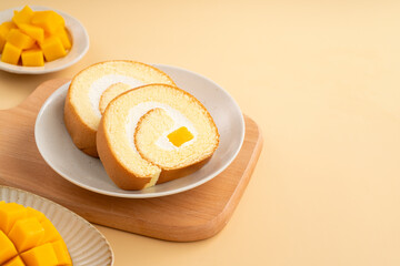 Delicious mango cream Swiss roll cake on plate