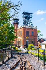 Sevcinsky mine in Brezove hory, Pribram, Czechia presents well-preserved architecture and mining equipment, highlighting the rich mining history of the region under a clear blue sky.