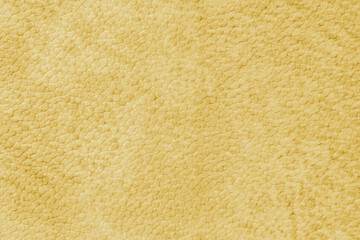 Fototapeta premium Detailed close up, macro of yellow synthetic suede leather texture, faux leather, leatherette. Background for design, fashion, upholstery material visuals. Natural grain structure, soft look.