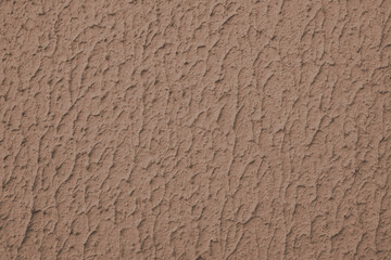 Close up of textured brown color painted wall with rough stucco, plaster wall texture. Vibrant background, wallpaper, backdrop, design element.