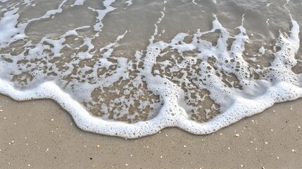 Obraz premium Ocean Wave Foam on Sandy Beach Shore