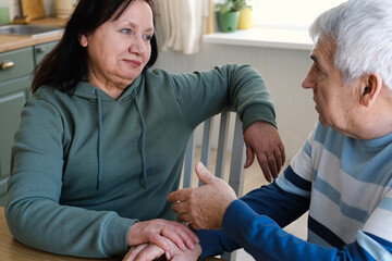 Senior couple hugging each other, kissing at home bedroom. Intimate Moment. Tender embrace between elderly age man and woman, husband and wife. Old people deep love. Time and feelings. Loving family