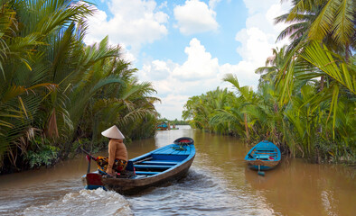 Fisherman is fishing in Mekong river in the morning - People boating in the delta of Mekong river,...
