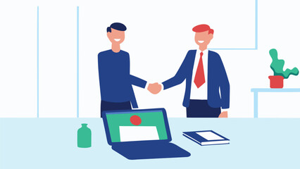 Two businessmen shaking hands in an office with a laptop and plant on the desk visible in the scene