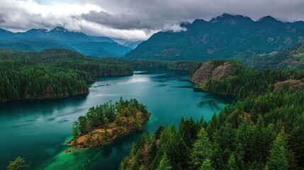 A turquoise blue lake surrounded by greenery, mountains, and forests that from a bird's-eye view, captures in daylight with natural light, creating a beautiful landscape.