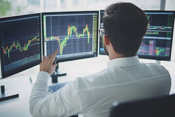 Focused businessman analyzes complex stock charts across multiple monitors in sleek, high-tech office setting.