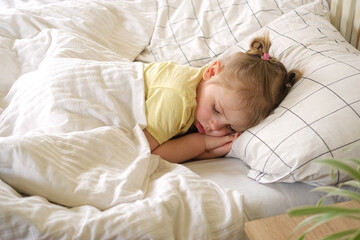 Peaceful adorable baby sleeping on a bed at home. Slumbering little child. Two years old girl...