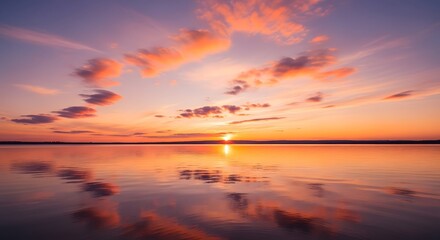 Fototapeta premium Beautiful calm ocean sunset with colorful sky and peaceful water reflection landscape background nature scene