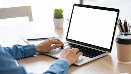 Image of a laptop computer with a white screen for advertising purposes, viewed from over the shoulder in a close-up shot, showing writing and typing text, representing a freelance concept for online.