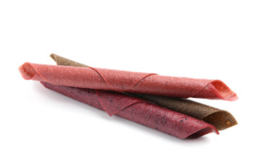 Delicious fruit leather rolls on white background