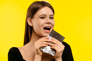 Young Woman Enjoying a Piece of Dark Chocolate Delight