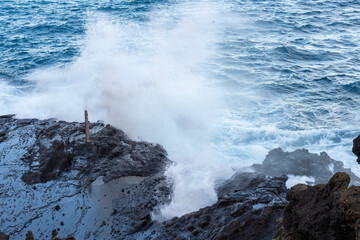 Heavy surf launches seawater skyward through Hawaii’s Halona Blowhole, capturing nature’s force at one of Oahu’s most thrilling coastal attractions.