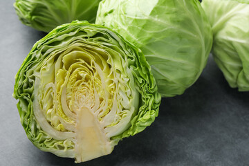 Fototapeta premium Fresh green cabbages on grey table, closeup