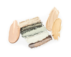 Colorful eyeshadows and foundation on white background, top view