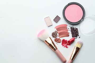 Different cosmetic products and makeup brushes on white background, flat lay. Space for text