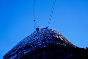 A view of steep mountainside leading up to the viewpoint at Rampestreken seen from the railway...