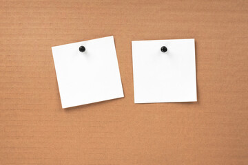 Fototapeta premium Blank notepaper and space for text with push pins on cardboard background. note blank paper cards. noticeboard on catron board. sticker. blanks for designers