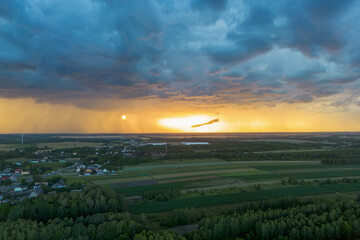 Rural landscape at sunset with dramatic storm clouds
