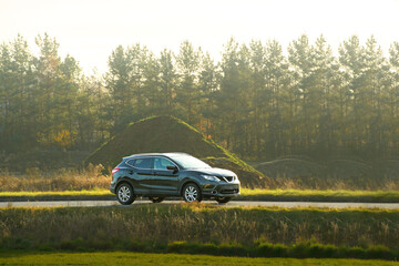 Elegant car driving through natural landscape