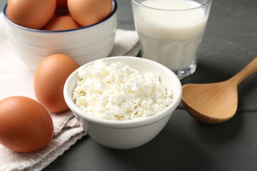 Different dairy products and eggs on grey wooden table, closeup