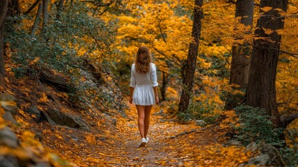 Red-haired woman in white dress and sneakers strolls along autumn forest path with vibrant orange and yellow foliage, evoking seasonal outdoor leisure and nature exploration