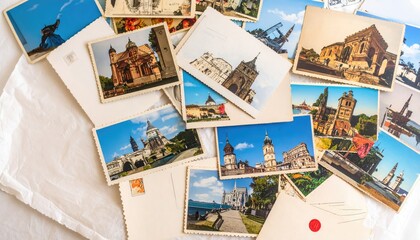 Assortment Of Vintage Postcards Featuring Architectural Landmarks Over White Fabric Background