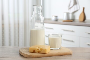 Dairy products. Fresh milk and cheese on wooden table in kitchen